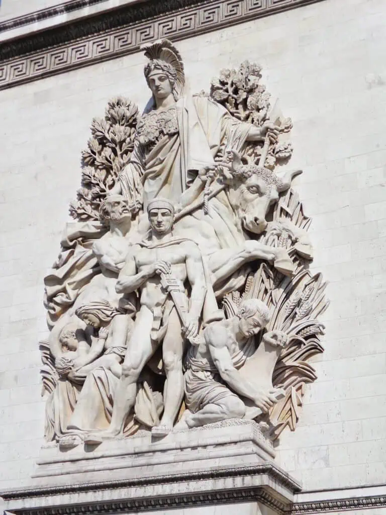How to Spend a Day in Paris, France: An Affordable, Speedy Itinerary 19 Close-up of a detailed stone sculpture on the Arc de Triomphe in Paris, depicting figures in motion with dramatic expressions and flowing garments. A key historic monument often visited during 3 days in Paris, France.