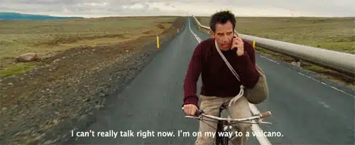 75 Movies Set in European Destinations to Inspire Your Next Trip 45 Scene from The Secret Life of Walter Mitty (2013) showing Walter riding a bike down an empty road through a vast Icelandic landscape while talking on the phone. The subtitle reads, “I can’t really talk right now. I’m on my way to a volcano.”
