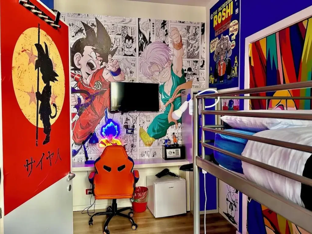 Reviewing Comics Guesthouse Roma as a Fan: Is It the Best Hostel in Rome, Italy? 6 Dragon Ball–themed room with large character art of Goku and Trunks, a gaming chair, and manga panel wallpaper at Comics Guesthouse hostel in Rome, Italy.