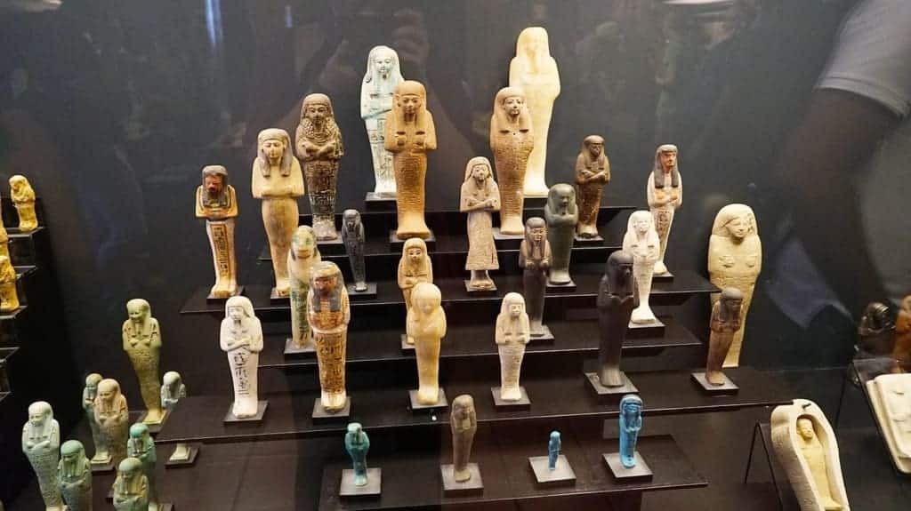 What Is There to See in the Vatican Museums? Walkthrough Guide + Travel Tips 7 Several small sarcophagi on display in the Gregorian Egyptian Museum within the Vatican Museums, each carved with relief scenes and set side-by-side in a low glass-case exhibit, in Vatican City.