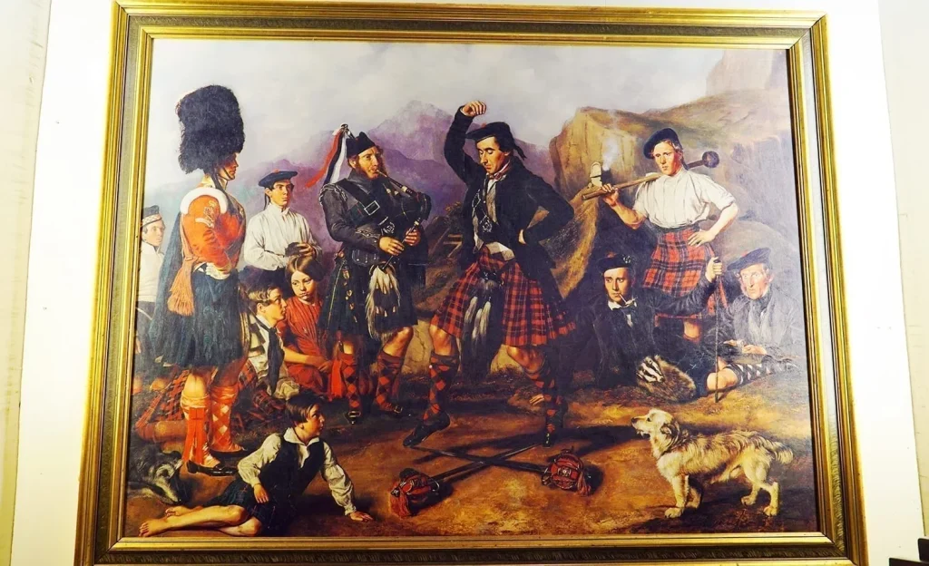 How to Visit Stirling Castle, Scotland: An Easy Day Trip by Train 26 Framed painting at the Argyll and Sutherland Highlanders Museum depicting Scottish soldiers in uniform dancing with dramatic mountains behind.