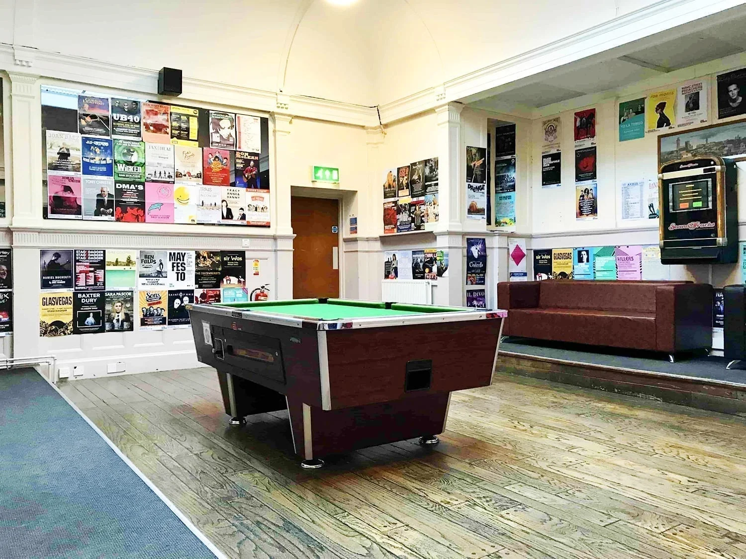 Glasgow Youth Hostel Review: Is it the Best Place to Stay? 6 Recreation room at SYHA Glasgow Youth Hostel featuring a pool table, seating, and colorful wall decor in Scotland.