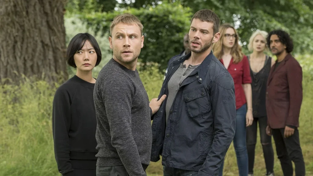 24 TV Series Set in Europe That'll Inspire Your Next Vacation 23 Scene from Sense8 Season 2, Episode 8 showing characters in a dramatic moment with emotional expressions surrounded by greenery.