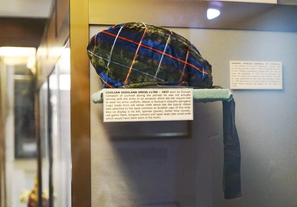 How to Visit Stirling Castle, Scotland: An Easy Day Trip by Train 27 Display of traditional civilian Highland dress at the Argyll and Sutherland Highlanders Regimental Museum, featuring a tartan cap at Stirling Castle.