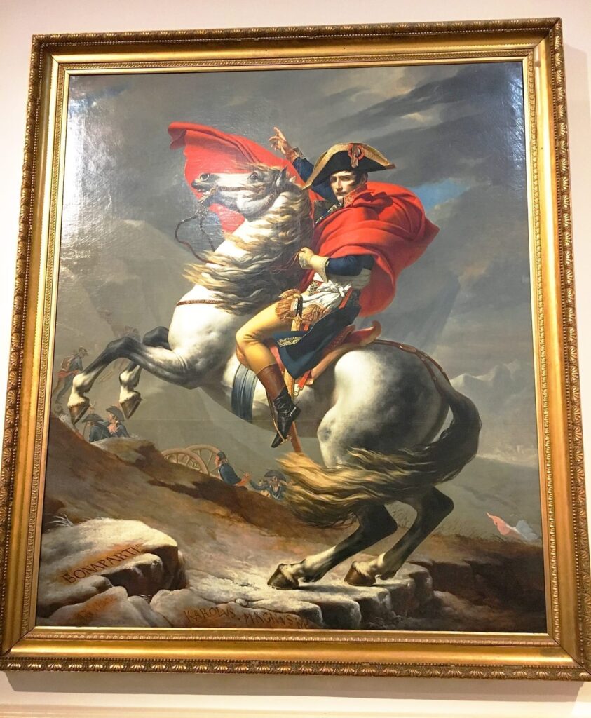 5-Day Austria Travel Itinerary: How to Visit Vienna and Salzburg on a Budget 29 Painting of Napoleon Bonaparte on display at the Belvedere Palace in Vienna, showing him in a regal military uniform with a dramatic pose on a horse, framed ornately against a wall.