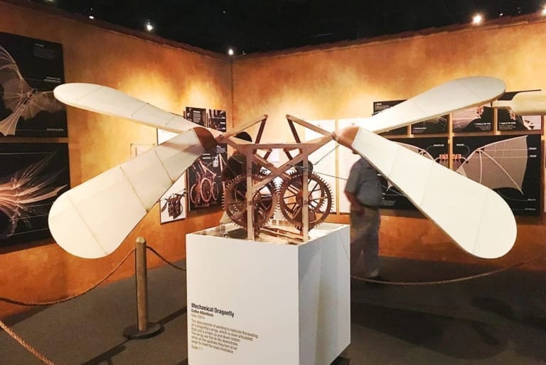 Display of the Mechanical Dragonfly invention with posters of diagrams and sketches behind it at the Leonardo da Vinci Exhibit at the Ronald Reagan Presidential Library in Los Angeles, California, USA.