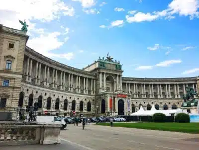 Exterior of the Imperial Hofburg Palace in Vienna, Austria, showcasing grand Baroque architecture and ornate statues. Historical residence connected to Empress Elisabeth and Emperor Franz Joseph I.