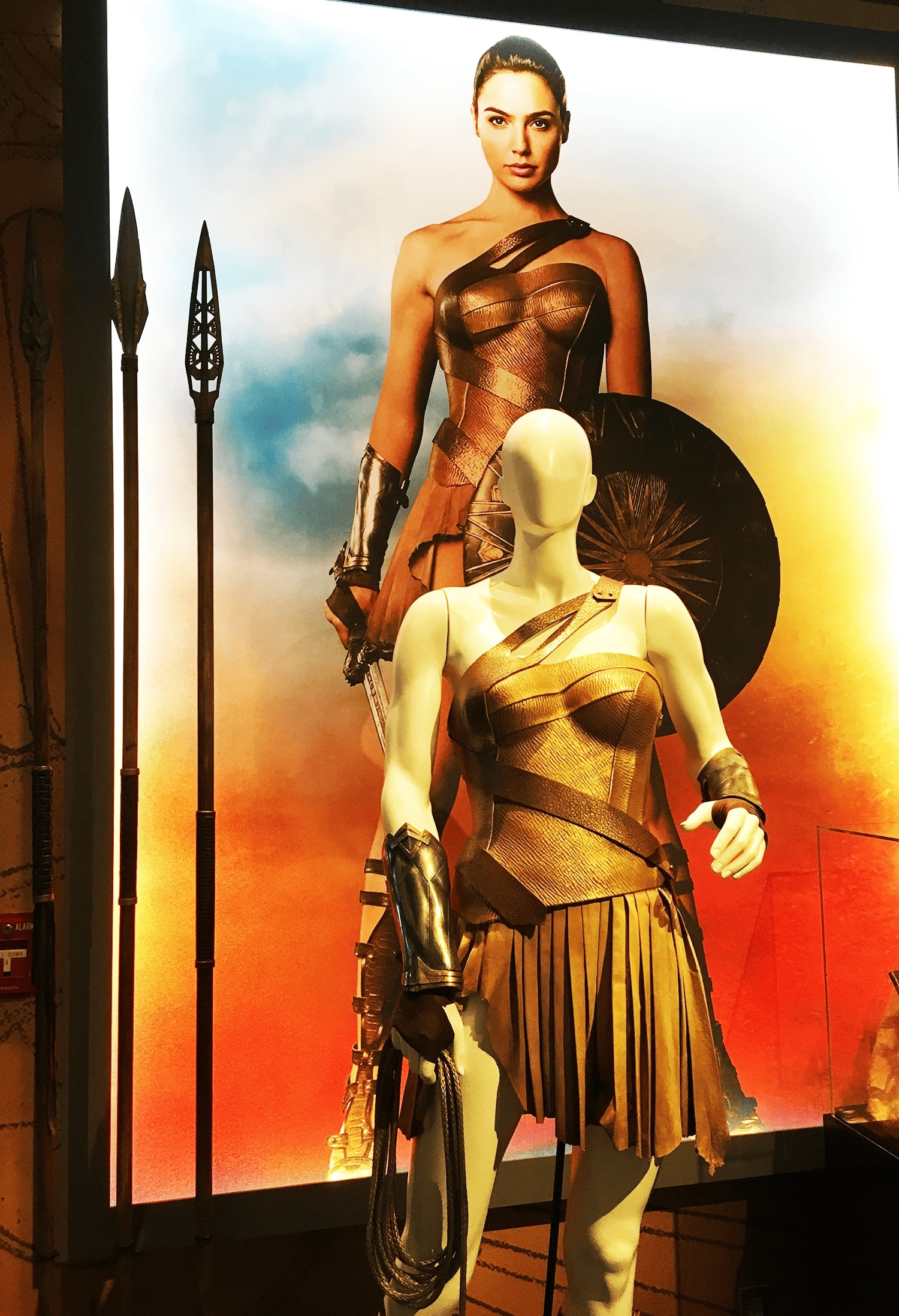 21 Cool, Nerdy Things to Do in LA—Activities for Kids to Adults 9 Gal Gadot’s Wonder Woman costume on display, featuring the signature gold armored bodice and lasso, showcased under dramatic lighting at a studio exhibit in Los Angeles.