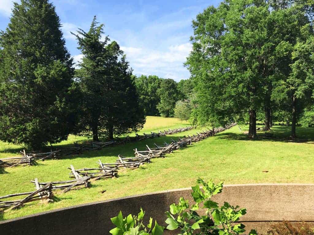 6-Day United States History Road Trip Itinerary Inspired by Hamilton the Musical 32 Open field at Yorktown Battlefield, with grasses and scattered trees under a wide blue sky, representing the historic site where American and French forces fought the final battle of the Revolutionary War.