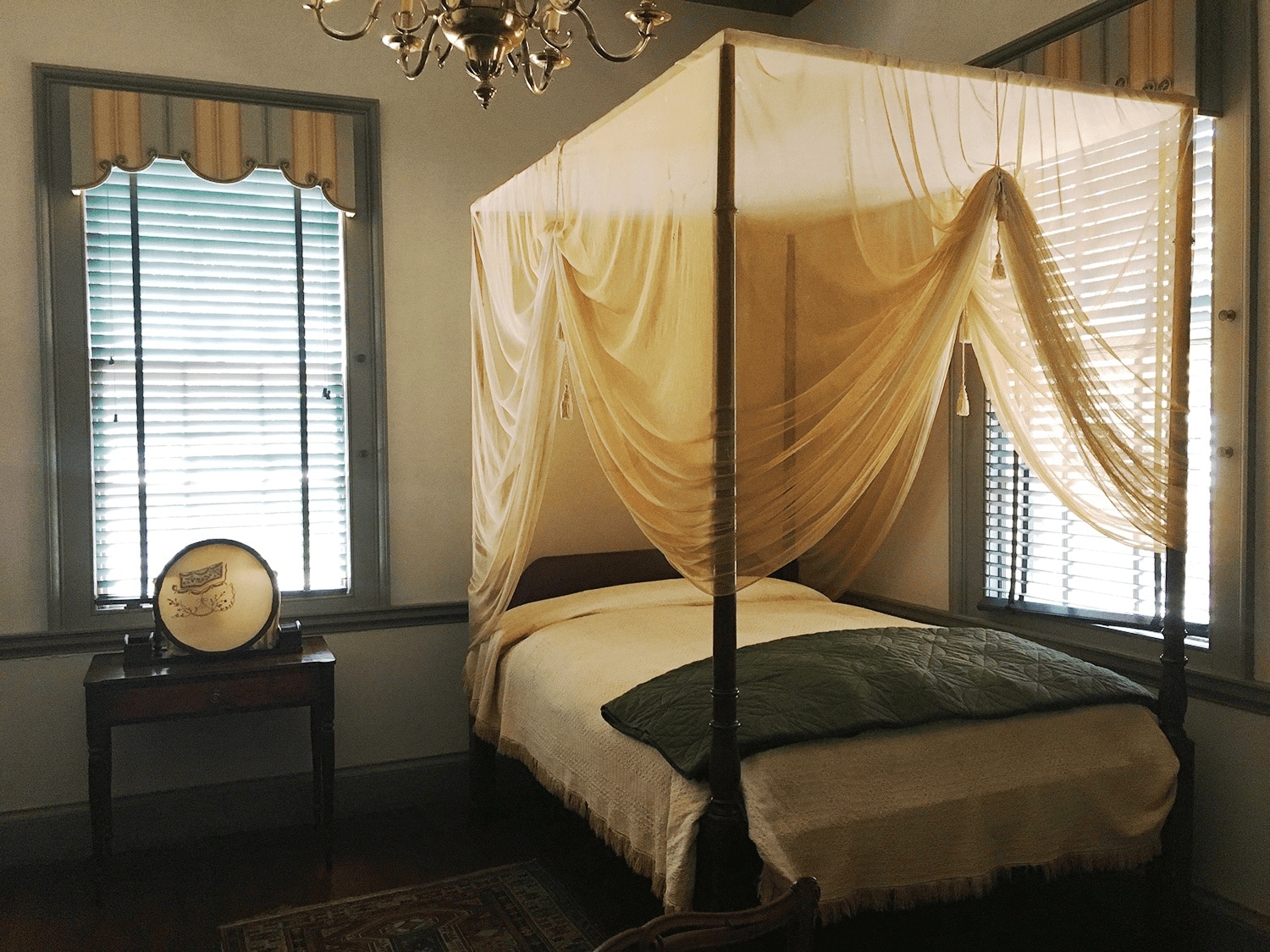 6-Day United States History Road Trip Itinerary Inspired by Hamilton the Musical 5 Bedroom inside the John Wright Stanly House, featuring a canopied four-poster bed with white linens and wooden furniture, all styled in authentic 18th-century American colonial decor.
