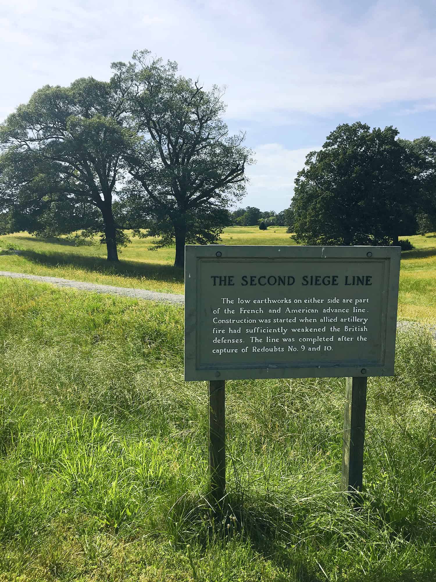 6-Day United States History Road Trip Itinerary Inspired by Hamilton the Musical 31 The Second Siege Line at Yorktown Battlefield, marked by grassy trenches and earthworks, with historical markers showing troop positions from the final Revolutionary War battle.