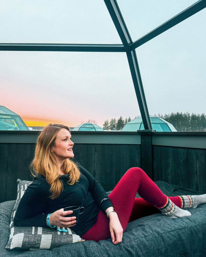 Looking for a Travel Companion? the Best Questions to Ask Before Your Next Trip 4 Woman relaxing in glass igloo accommodation at the Arctic Snow Hotel in Finland