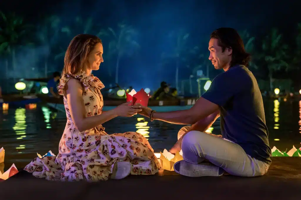 18 of the Best Netflix Travel Movies to Watch for Trip Inspiration 2 Scene from A Tourist’s Guide to Love featuring the main characters exploring Vietnam, highlighting culturally rich travel movies on Netflix.
