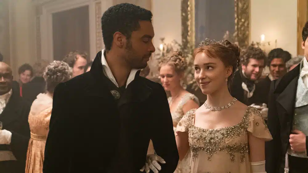24 TV Series Set in Europe That'll Inspire Your Next Vacation 3 Promotional image for the Bridgerton TV series featuring main cast members in Regency-era costumes.