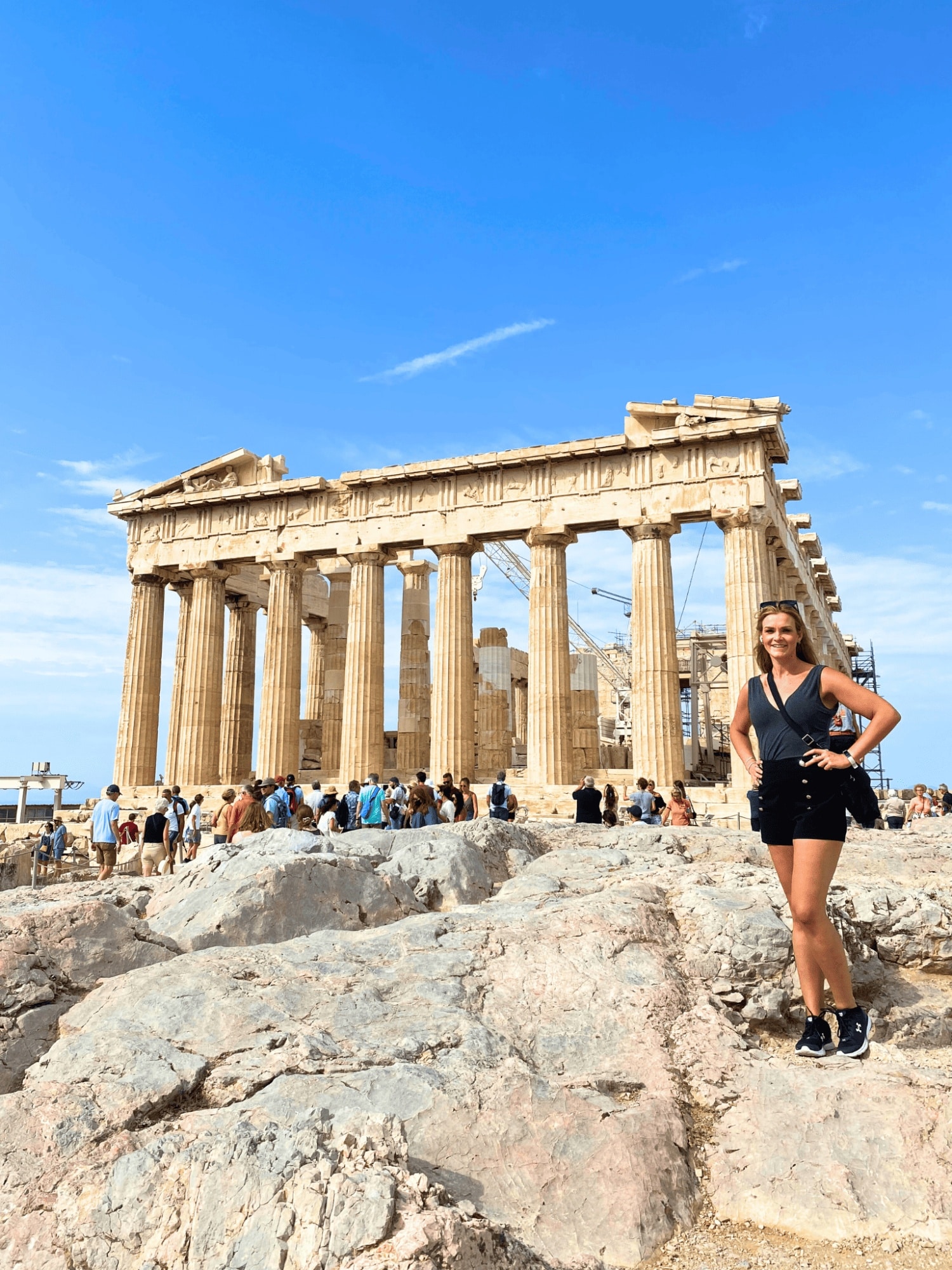 What to Wear in Greece: A Practical Packing List for Women 3 Woman posing before the Acropolis in Athens Greece