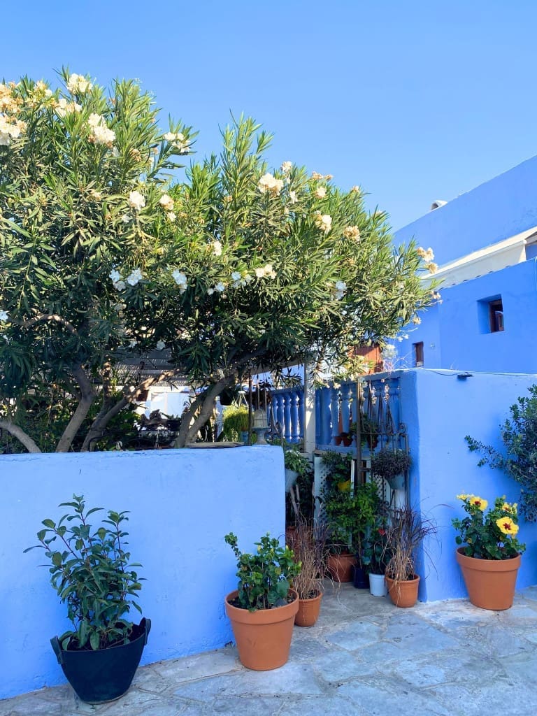 Santorini, Greece Travel Guide: Essential Tips for First-Time Visitors 22 Blue house on Santorini Island with stunning views of the Aegean Sea.