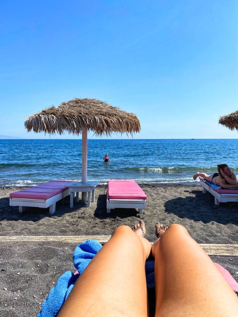 Where to Stay in Santorini, Greece: 8 Key Areas for First-Timer Visitors 7 Perissa Black Beach on a sunny day in Santorini Greece.