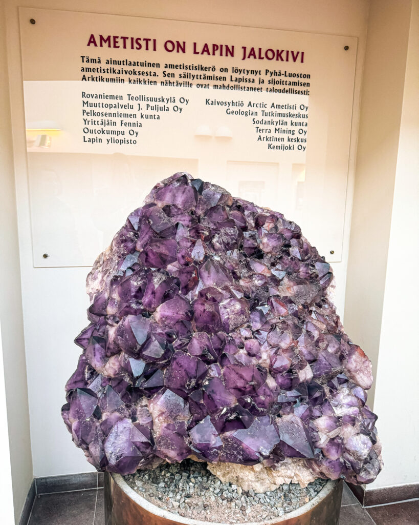 The Best Hotels in Rovaniemi, Finland: Comparing My Glass Igloo Stay with the City Center 10 Amethyst exhibit at Arktikum Museum in Rovaniemi showcases stunning purple gemstone.