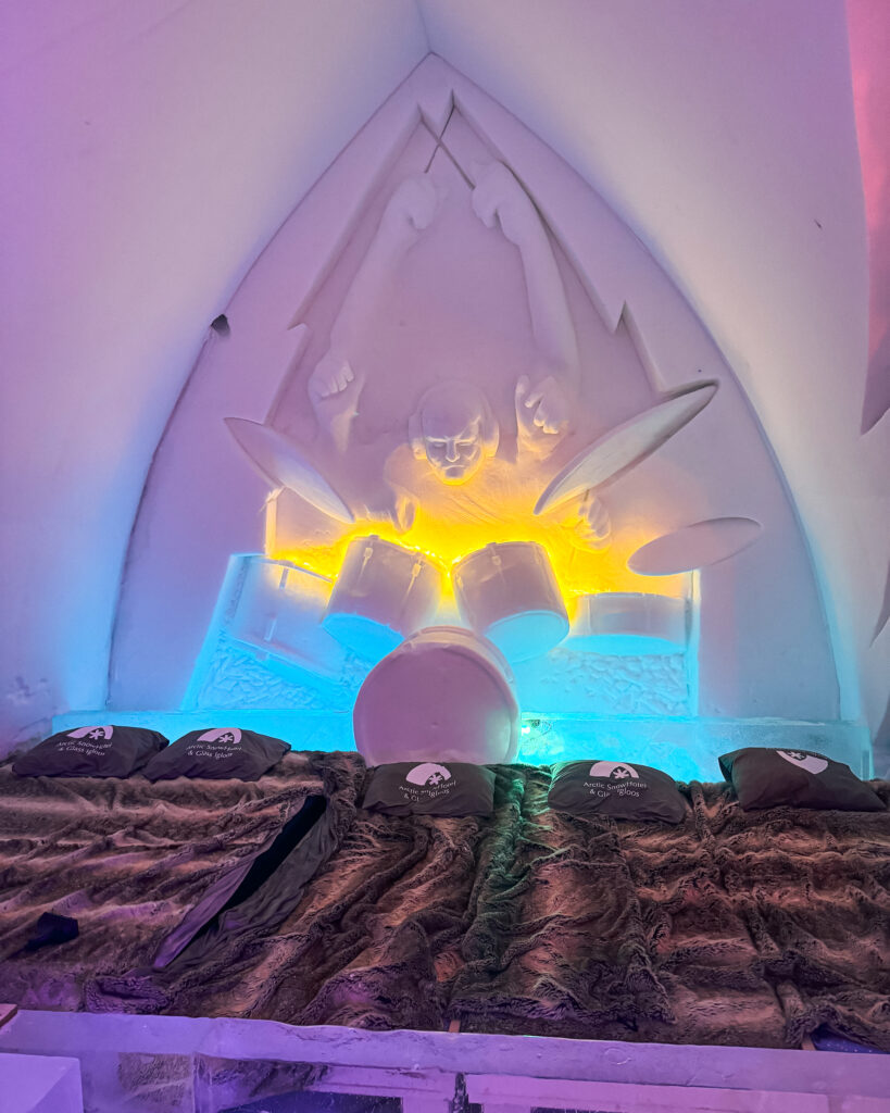 The Best Hotels in Rovaniemi, Finland: Comparing My Glass Igloo Stay with the City Center 26 Drummer sculpture in art room at Arctic SnowHotel & Glass Igloos, Lapland Finland.