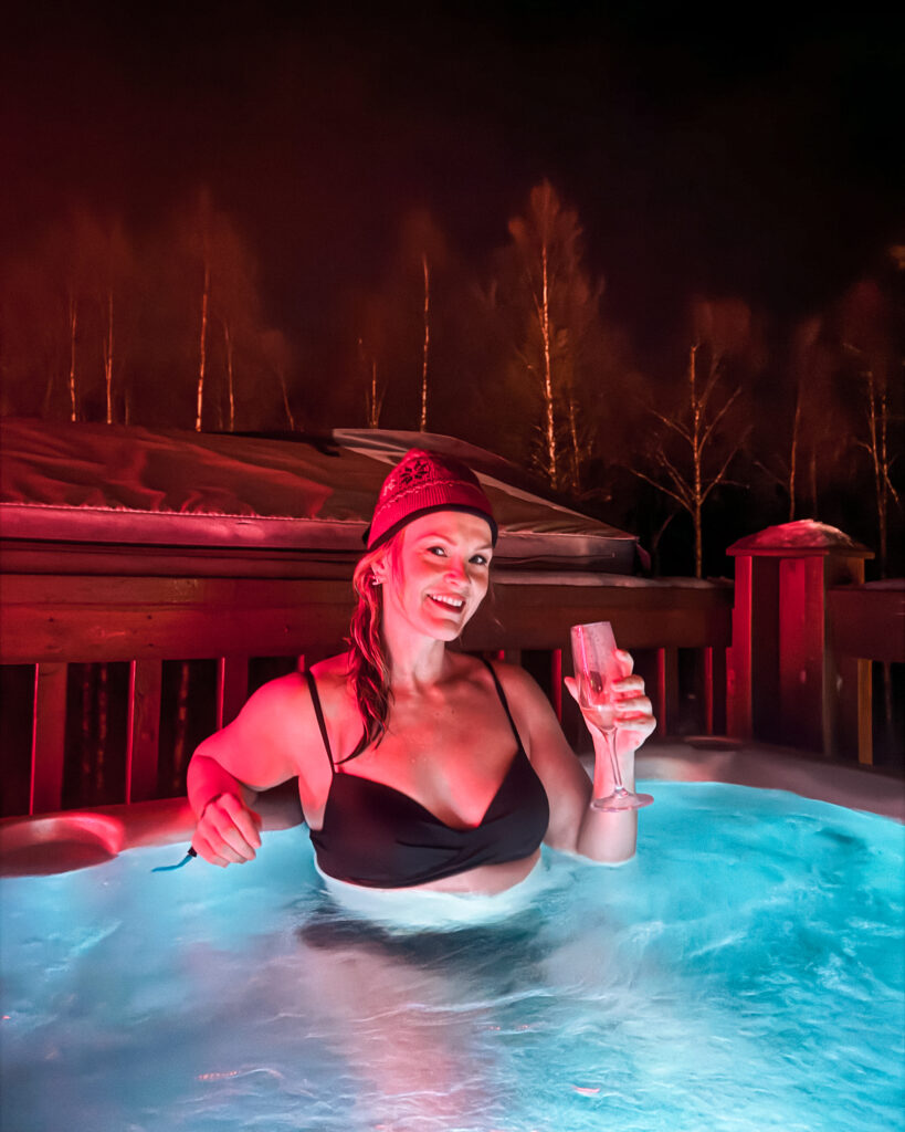 The Best Hotels in Rovaniemi, Finland: Comparing My Glass Igloo Stay with the City Center 47 Woman enjoying snow jacuzzi at Rovaniemis Arctic SnowHotel & Glass Igloos in Finland.