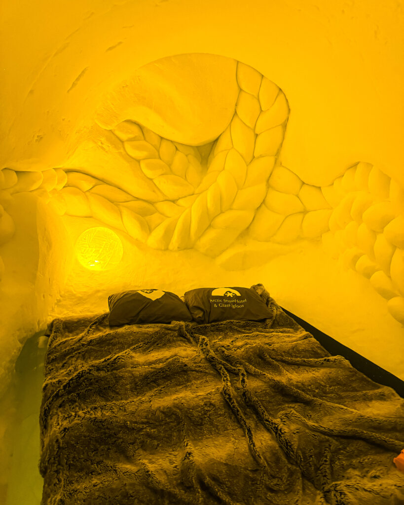 The Best Hotels in Rovaniemi, Finland: Comparing My Glass Igloo Stay with the City Center 50 Luxury yellow yarn room at Arctic SnowHotel & Glass Igloos in Lapland, Finland.