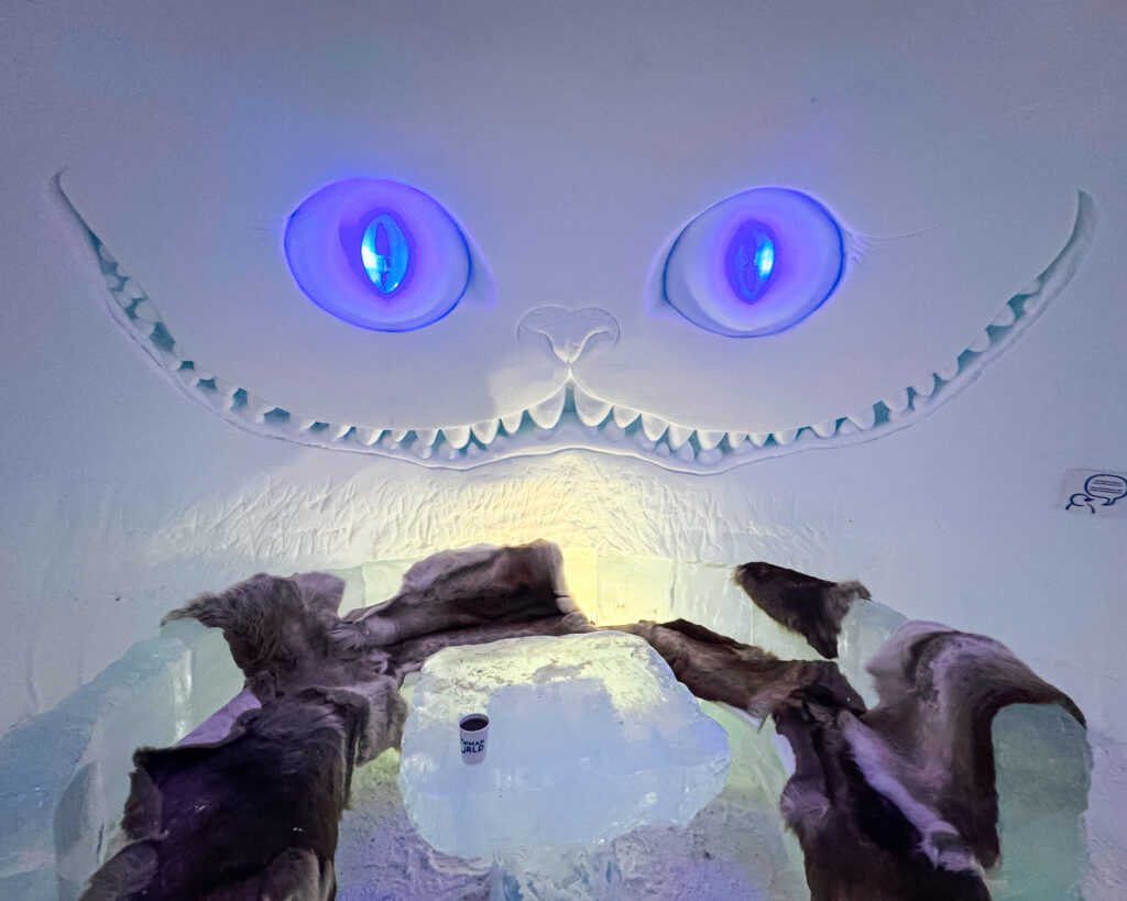 30 of the Best Things to Do in Rovaniemi, Finland, This Winter 45 Snowman World Cheshire Cat snow sculpture at Ice Bar in winter wonderland.