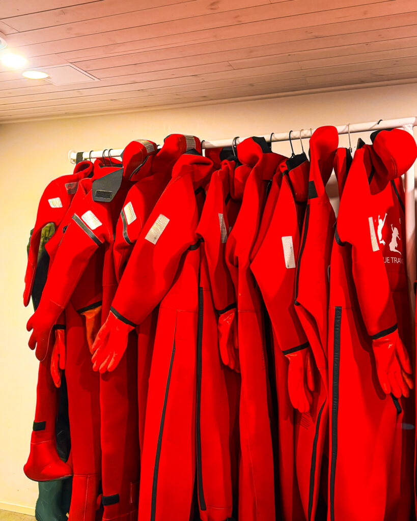 My Epic Experience Ice Floating in Rovaniemi, Finland: Honest Tour Review 2 Red ice floating suits in Lapland for a fun outdoor adventure.