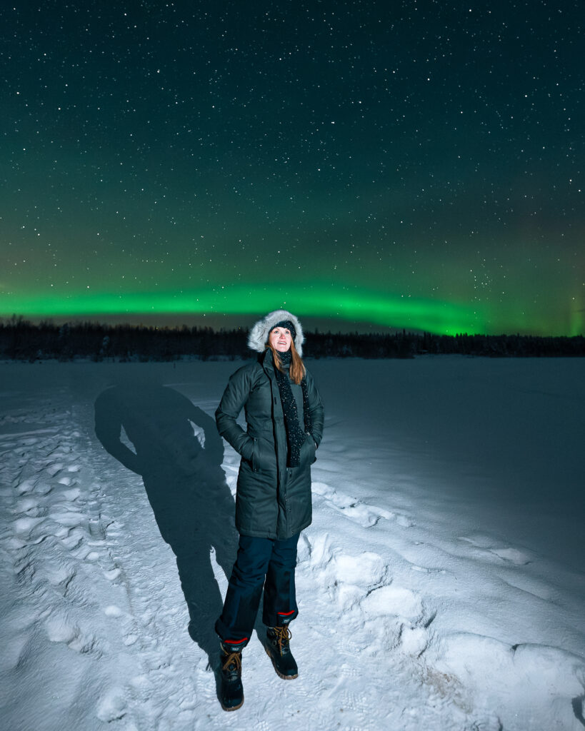 The Best Hotels in Rovaniemi, Finland: Comparing My Glass Igloo Stay with the City Center 59 Woman experiencing Aurora Borealis in Finland.