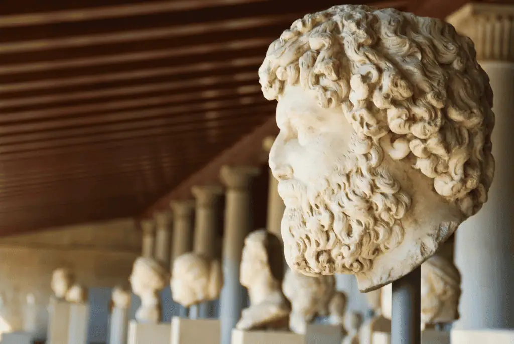 Is Athens Worth a Visit? 24 Reasons to Explore Greece's Ancient Capital 12 Stone busts of ancient figures displayed on pedestals inside the Agora Museum in Athens, Greece. The statues are arranged along a wall with warm lighting that highlights their detailed facial features and classical style.