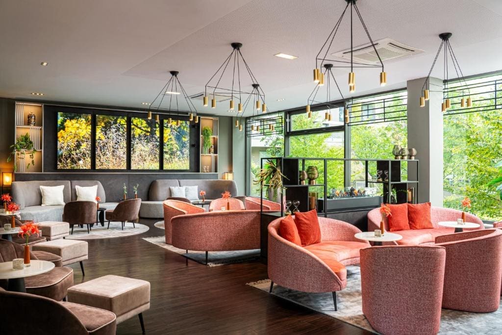 Where to Stay in Vienna, Austria: My Favorite Areas + Best Budget Hotels 80 leonardo hotel vienna schonbrunn lounge coral sofas vienna austria