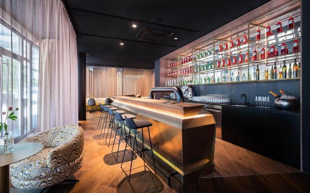 Where to Stay in Vienna, Austria: My Favorite Areas + Best Budget Hotels 100 mooons hotel vienna indoor bar gold counter vienna austria