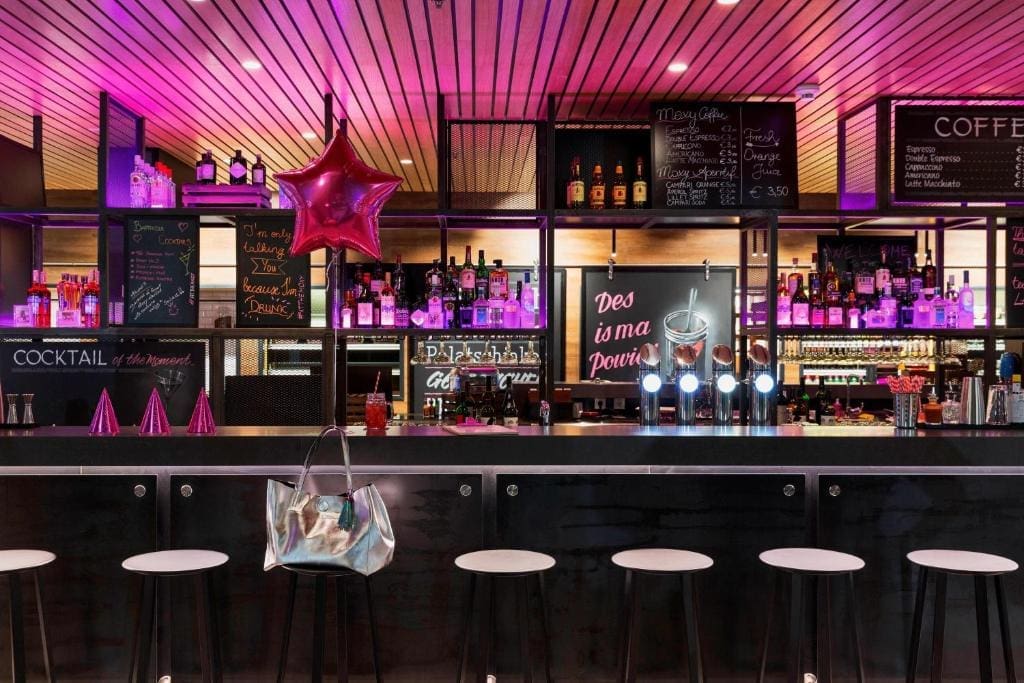 Where to Stay in Vienna, Austria: My Favorite Areas + Best Budget Hotels 117 moxy vienna airport bar neon lighting schwechat austria