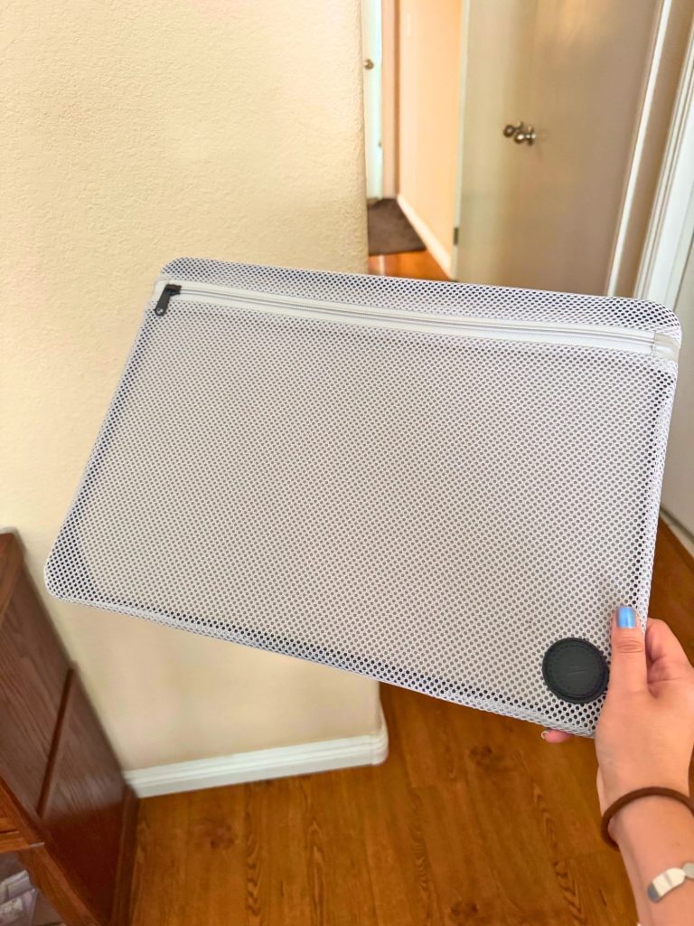 How to Choose a Vacuum-Seal Carry-On: Complete Guide for Space-Saving Travelers 8 BlackVoyage AirCabin Pro carry on suitcase's interior divider, which includes a zippered neutral-toned mesh section and slip pockets for organized storage.