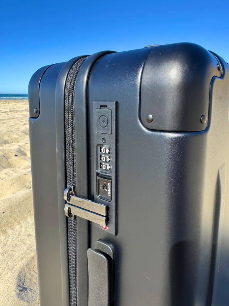 How to Choose a Vacuum-Seal Carry-On: Complete Guide for Space-Saving Travelers 4 Side of the BlackVoyage AirCabin Pro carry on suitcase, featuring USB-A and USB-C charging ports, an integrated TSA-approved lock, puncture-resistant zipper, and aluminum alloy corner caps.