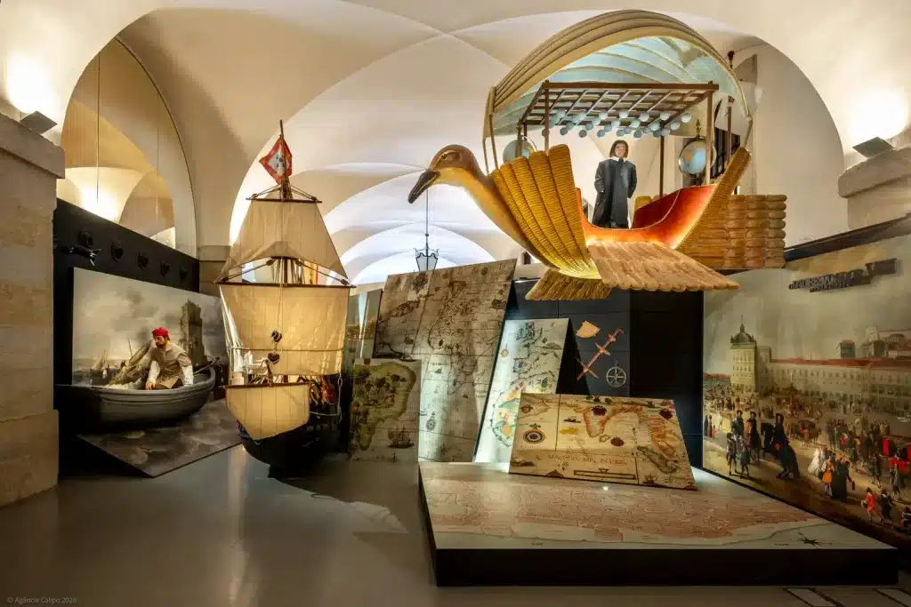22 of the Best Things to Do in Lisbon, Portugal (My Budget-Friendly Picks) 23 Interactive exhibition hall at the Lisbon Story Centre featuring a replica Portuguese caravel, a large sculpted seabird, antique map reproductions, and historical dioramas depicting the Age of Discovery, all displayed beneath vaulted stone arches with dramatic accent lighting.